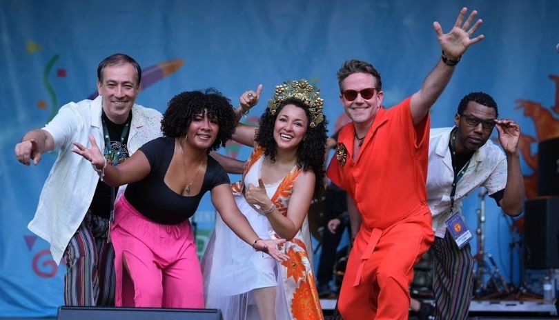 Afro-Andrean Funk band poses onstage at Sunfest 2024.