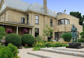 outdoor view of the Banting House National Historical Site building and flame of hope located in London, Ontario