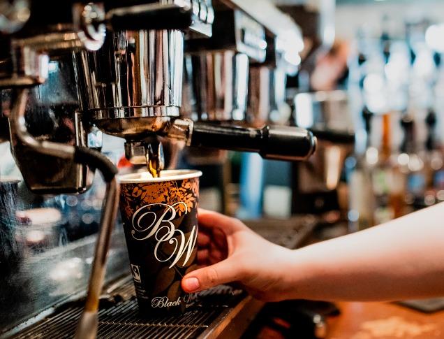 A Barista pouring water into a coffee filter