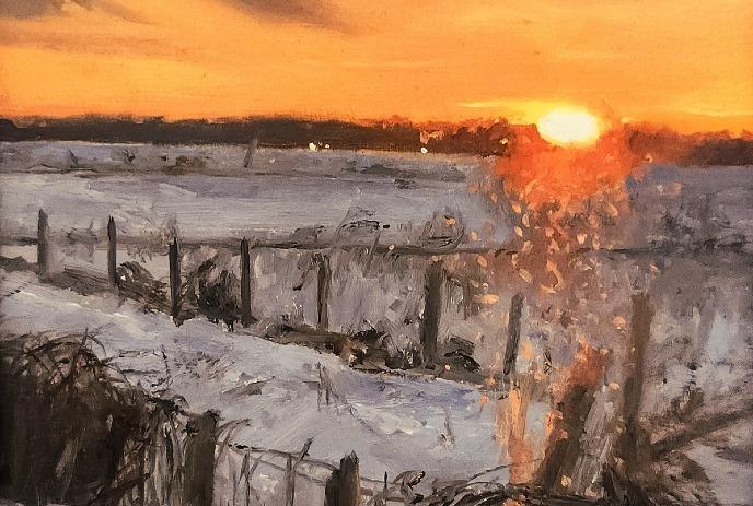 Snowy sunset over rural fence warm orange sky glows above cold white ground in peaceful winter landscape.