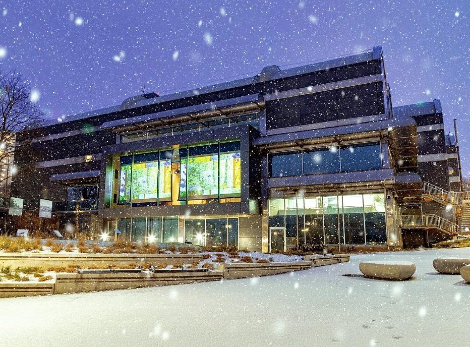The exterior of the Museum London building at night with snow falling, located in London, Ontario