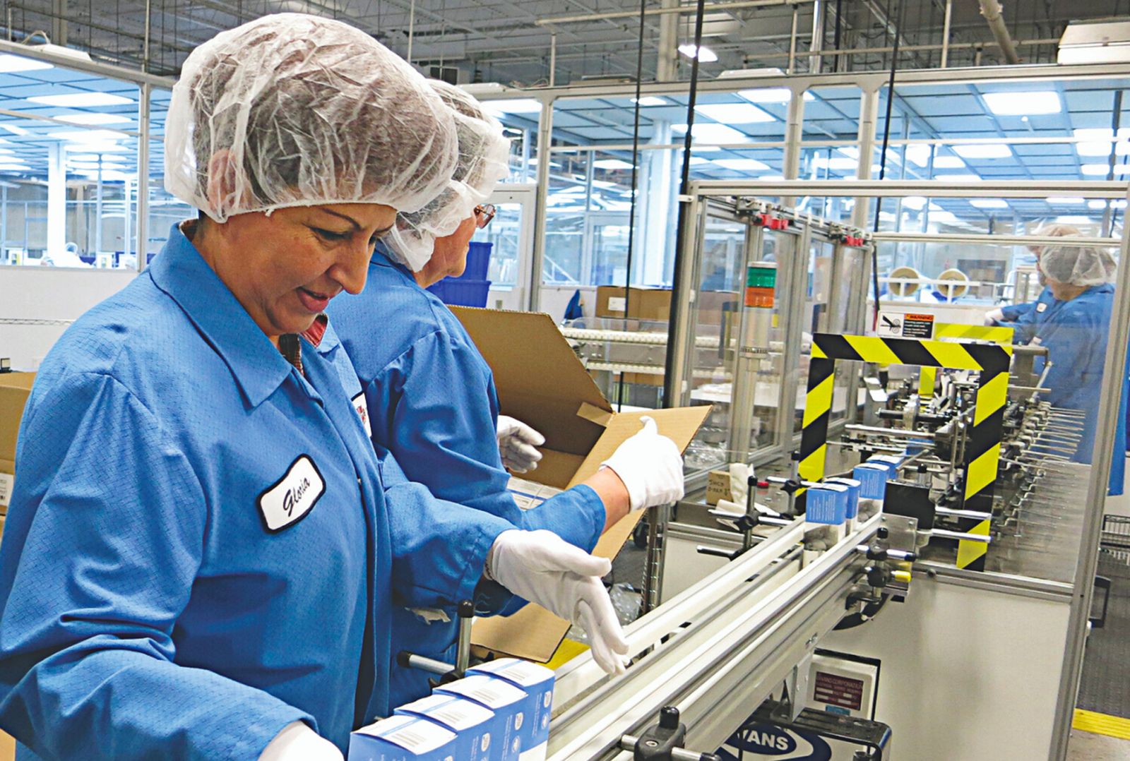 workers on an assembly line organizing procuct
