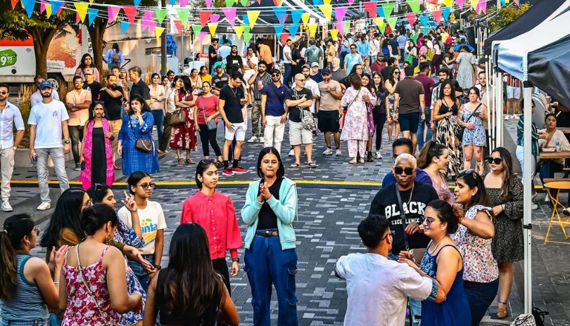Two females in traditional outfits posing for a picture,
