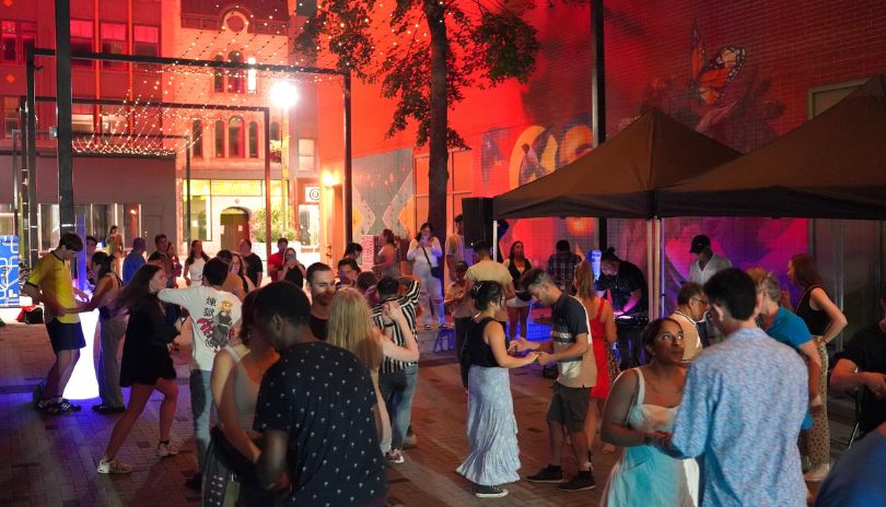 People dancing in the street of Dundas Place in  London, Ontario