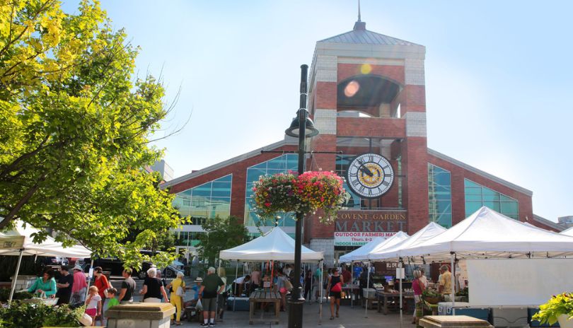 Covent Garden Markets rotary square filled with tent vendors and people.