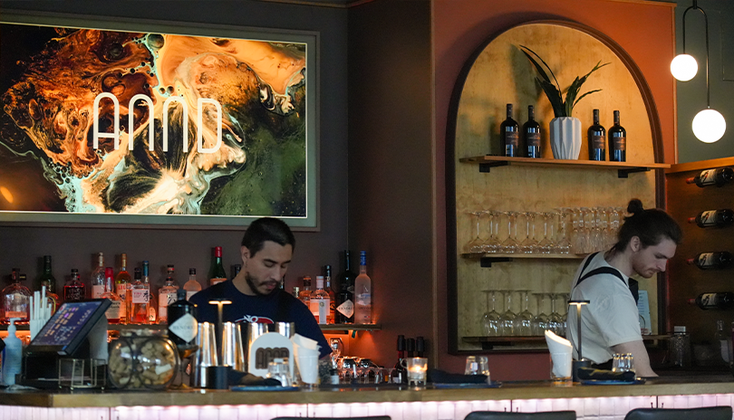 Two bartenders preparing cocktails at ANNDining