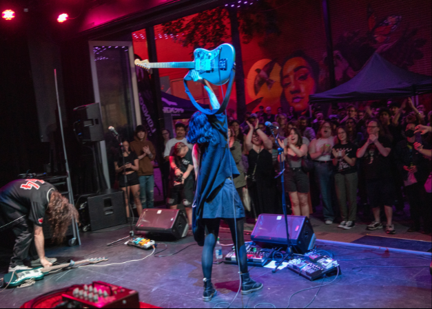 Artist Jey Khamari performing in Market Lane at the City of Music Concert Series