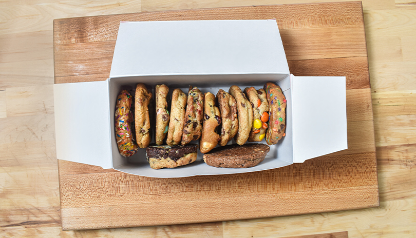 Box of fresh and warm cookies sitting on a counter