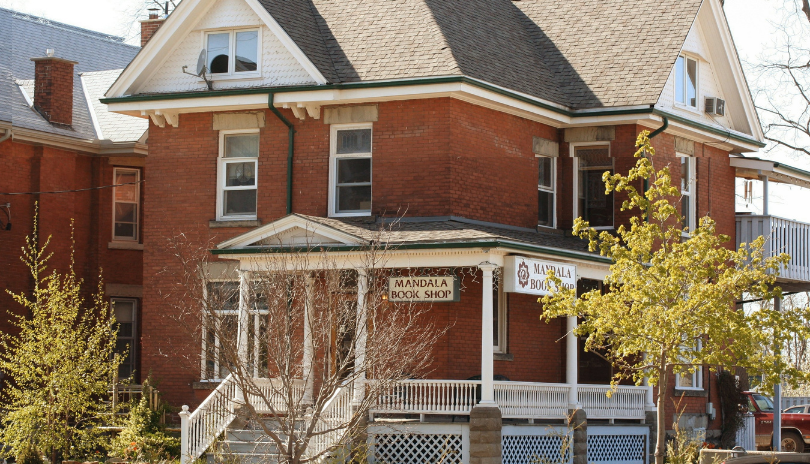 An old house with a sign for Mandala Book Shop on it.
