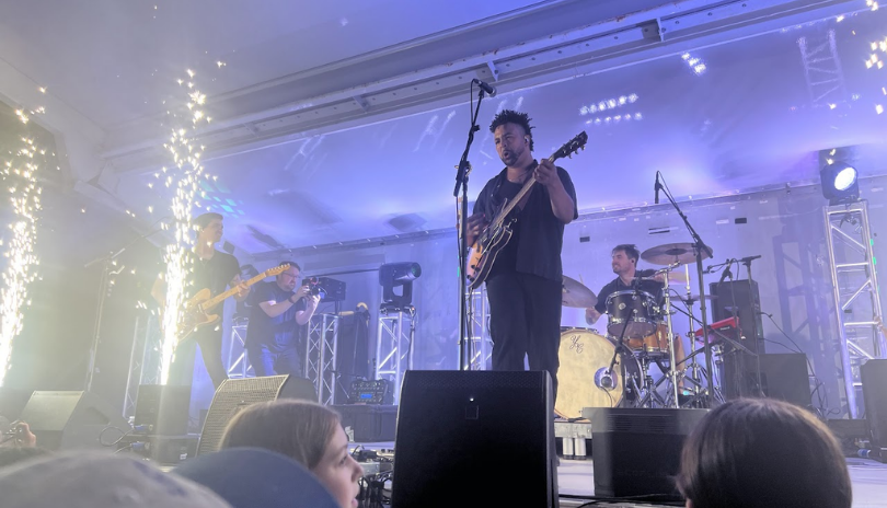 Texas King band plays on an outdoor stage lit with sparklers at Pondfest.