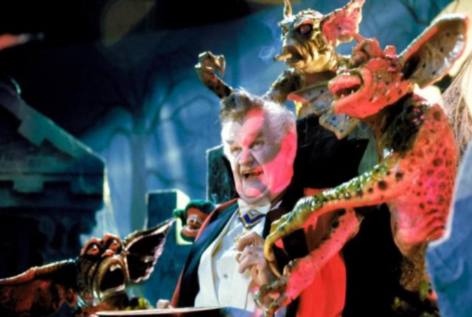 Three Gremlins attacking a person in a dark room.